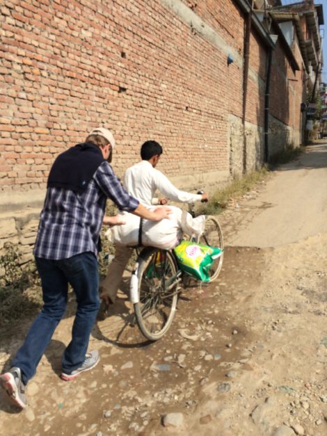 Walter Wheeler and shop owner bringing supplies to Nisha's family.