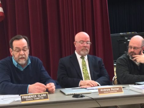 Andrew Potter, center, and Dan Weston, right, listen as Fred Clark urges there committee to cut programs in order to decrease the impact on Great Barrington taxpayers.