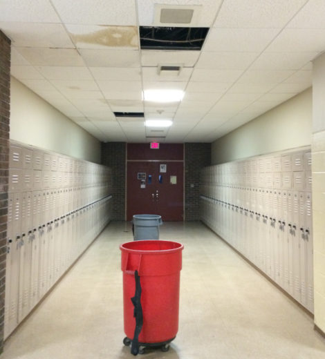 During a rainstorm barrels line a Monument High hallway to catch leaks from the roof.