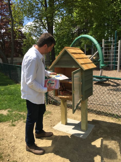 Ed Abrahams restocks the Book House at the Town Hall playground. Photo: David Scribner
