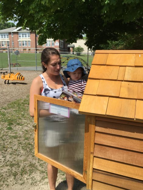 The youngest reader: Milena Stanton introduces her cousin, Lola Stanton, to the Book House at the Housatonic School playground. Photo: David Scribner