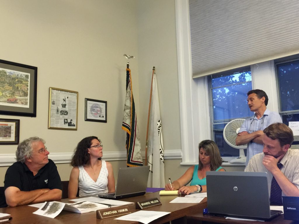 Jonathan Hankin and Brandee Nelson listen to CDC Executive Director Tim Geller (standing). Seated are Town Planner Chris Rembold, right, and secretary Kim Shaw. Photo: Heather Bellow.