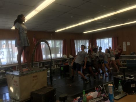 Brianna Nicola, on cart, with cast of THE WHIZ, in rehearsal. Photo: Hannah Barrett