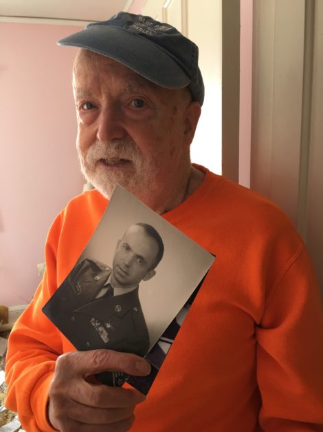 Don Victor with a photograph of himself when he was in the Air Force.