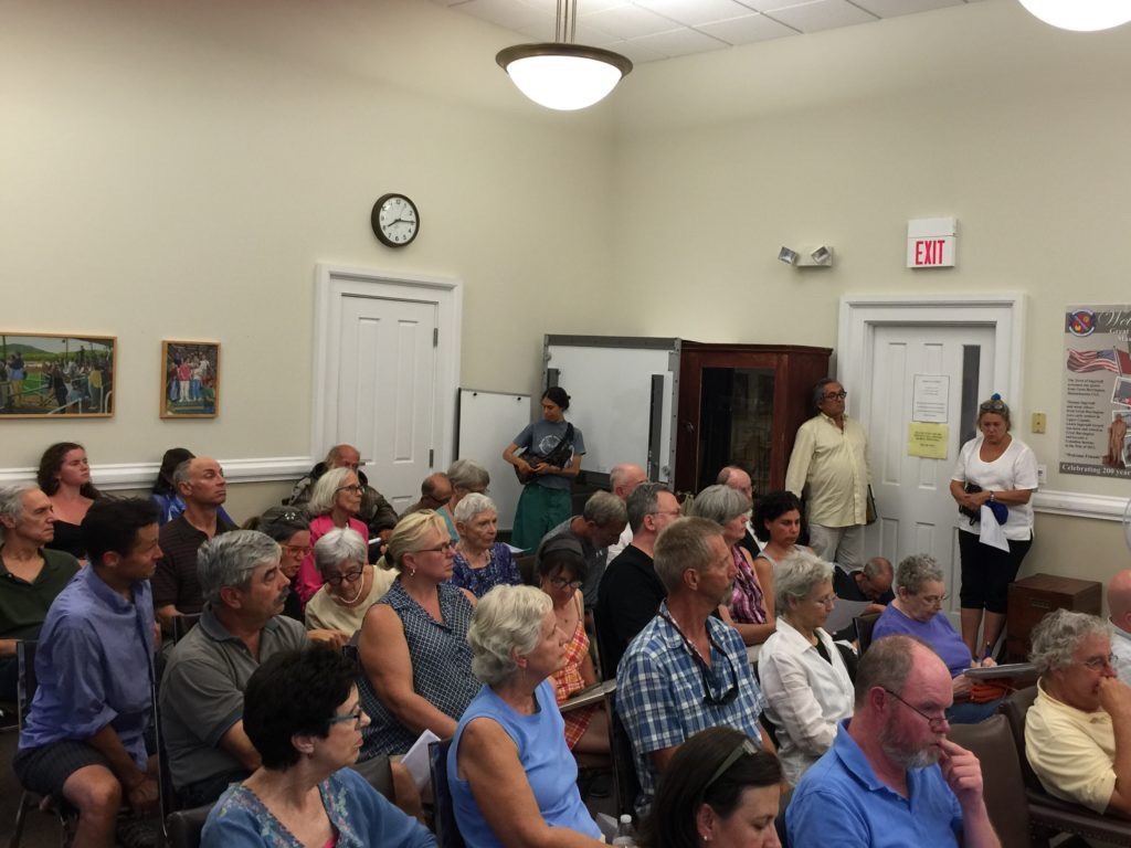 The July Zoning Board of Appeals hearing about 45 affordable housing units on a partially remediated site was packed with concerned residents, CDC board members and town officials. Activist Nan Wile is in a white shirt, seated second from right in the second row. Photo: Heather Bellow