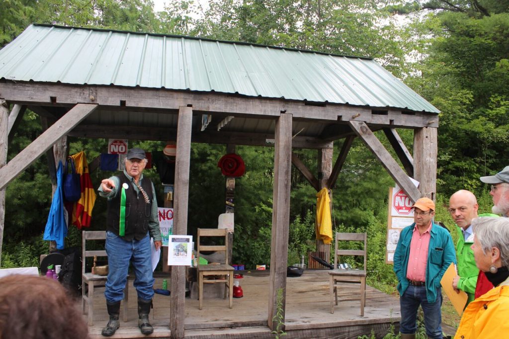 Cabin builder Will Elwell points to activity on the pipeline easement, as Ashfield Selectman Ron Coler and Sen. Adam Hinds, right, look on. Photo: Terry Cowgill