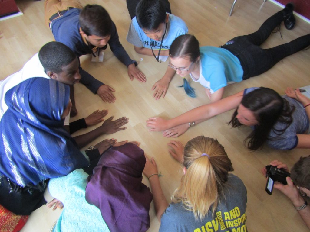 Music in Common participants, including refugee and American-born teens, play a rhythm game at a recent Music in Common program. Photo courtesy Music in Common