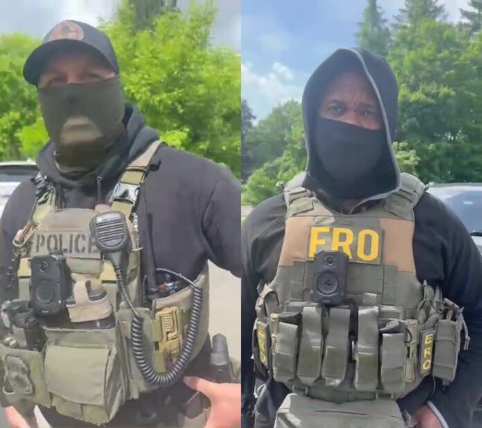 Two agents from U.S. Immigration and Customs Enforcement (ICE) as they take a man into custody in Great Barrington on Friday, May 30.