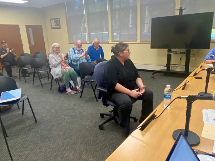 West Stockbridge full-time Police Officer Nicole Miller receives word that she will follow Chief Marc Portieri as the next to lead the town's department as the meeting audience applauds the announcement. Photo by Leslee Bassman.