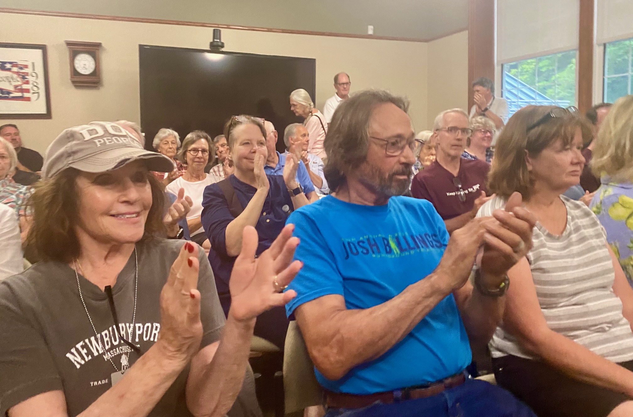 Stockbridge Special Election Forum guests applaud their candidates in a packed Select Board meeting room. Photo by Leslee Bassman.