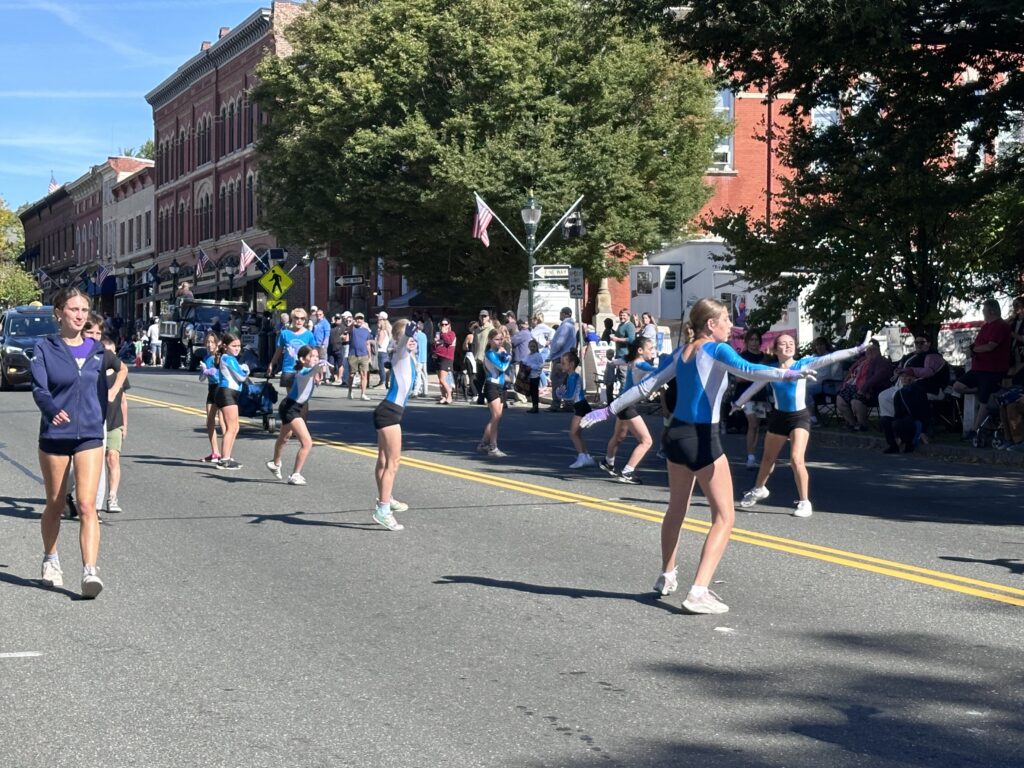 Gymnasts show off their talents along the parade route. Photo by Jodie Gordon.